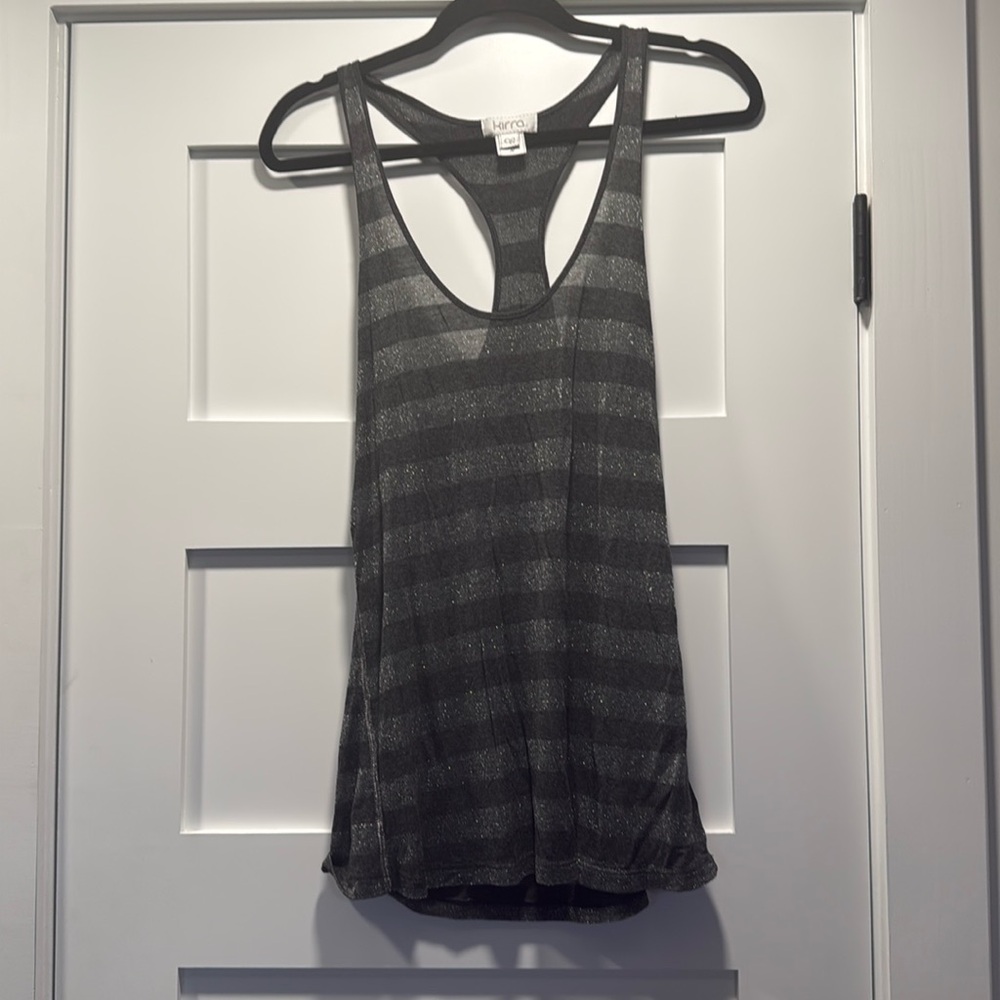 Shiny tank top made from a sleek blend of 85% rayon and 15% lurex.